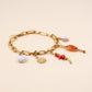 Bracelet grigris - Octobre Rose - laiton doré à l’or fin - pierres naturelles : nacre, cornaline, corail, opale rose - l’Atelier des Dames