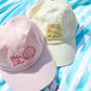 casquettes rose et jaune brodées sur serviette de plage- l'atelier des dames x broders cap
