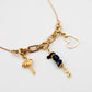 Composition de charms sur le collier fin doré avec 3 anneaux de la gamme GRIGRI - L'Atelier des dames